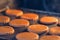 Round formed raw gingerbread dough on teflon baking sheet before to make cookies in the oven during baking