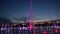 Round fountain at dusk with illuminated water jets