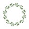 Round frame of green twigs and leaves. Design template for logo, invitation, greetings. Laconic stylish wreath. Border in a