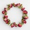 Round frame or wreath made of dried red roses on white. Creative template and holidays