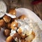 Round fried mozzarella cheese sticks under creamy sauce. Top view, from above