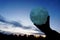 Round full moon in hands against evening sky