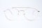 Round glasses for vision on a white background. Glasses with a gold metal frame