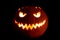 Round halloween pumpkin smile with hot burning fire eyes mouth