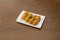 round ham croquettes fried on a white porcelain tray