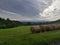 Round hay bails cloudy summer day mountaintop view