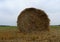 Round haystack on the farm field after harvesting stock image