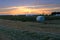 Round haystacks, spools on a mown field in the evening at sunset, harvest concept, agricultural