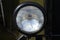 Round headlight of a military car, old-timer vehicle