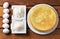 Round homemade biscuit cake on a plate, flour, sugar and eggs