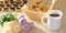 Round homemade curd cookies in a basket next to cup of tea and flowers