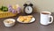 Round homemade curd cookies on a plate next to cup of tea and basket with flowers