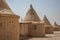 Round houses with conical pointed roofs, built by the English for the employees of the railways in Africa, at the edge of a