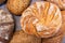 Round loaf of bread on background of different bread loaves. Bread collection top view background