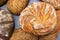 Round loaf of bread on background of different bread loaves. Bread collection top view background