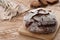 Round loaf of bread on a wooden background