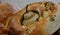 A round loaf of sour dough bread, baked with a pear in the centre and herbs sprinkled on top.