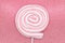 Round marshmallow lollipop on stick on shiny pink background