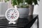 Round mechanical hygrometer on black table indoors. Space for text