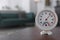 Round mechanical hygrometer on wooden table in room. Space for text