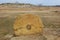 Round megalithic stone in the steppe.