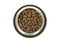 Round metal feeding bowl with heart shaped pet kibble seen from