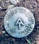 A round metal marker of Appalachian Trail