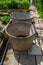 Round metal trough for water in a abandoned greenery