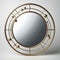 Round mirror with a narrow brass frame and a matte finish for n