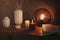 Round mirror on wooden shelf with two burning candles and small porcelain Buddha head
