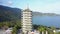 Round motion pagoda with white dome on hilly ocean coast