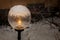 Round outdoor lamp in snowfall in winter