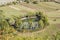 Round pond in green upland, near Calascio, Abruzzo, Italy