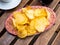 Round potato chips served in plate with a glass of vermouth