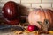 Round pumpkin and apple lie on shelf