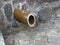 Round rain dry ceramic  pipe in the stone wall