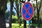 Round road sign with a red cross on a blue background. A sign means a parking prohibition