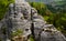 Round rock formations attract climbers. sandstone rock towers polished by wind erosion. deciduous, mixed forest with beeches in ea