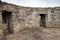 Round ruined interior with empty windows of old stone fort