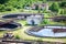 Round settlers at sewage treatment plant, aerial view