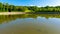 Round shape manmade pond with fish in a french classical garden (Vaux-le-Vicomte