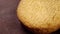 Round shortbread cookie on a rustic brown wooden surface. Fresh treat. Macro.