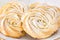 Round shortbread cookies roses form White plate. White background. Copy space.