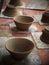 Round soft brown color formed clay for ceramic utensils bowls under production process in a factory