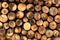 Round split logs piled in rows wood texture