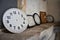 Round and square clocks against the wall, two clock dials, clock dial, many wall clocks, two old watches