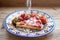 Round strawberry pie with fresh strawberries slice on plate dish on wooden table background