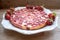 Round strawberry pie with fresh strawberries on white plate dish on wooden table background