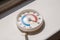 Round street outdoor thermometer with arrow shows extremely high temperature on hot sunny summer day