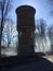 A round structure that looks like a brick tower. Water tower.